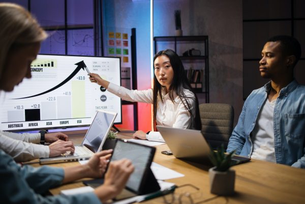 Multi ethnic economists analysing financial growth at office