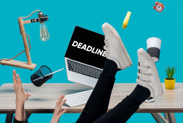 cropped view of girl levitating in air with laptop with deadline lettering on screen and stationery