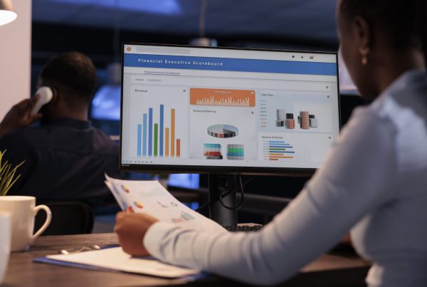 Office employee analyzing business charts on computer